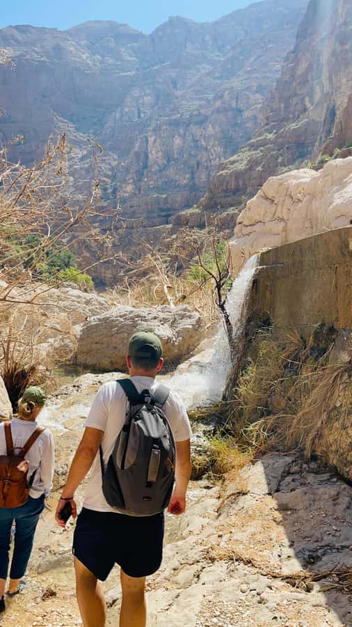 Muscat: Wadi Shab, Romantic Cave and Sinkhole Full-day Trip - Walking through Wadi Shab