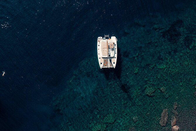 Romantic Sunset Catamaran Caldera Cruise incl. Meal & Drinks - Red Beach and White Beach from the water